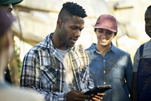 Young man with a taper fade working on a tablet